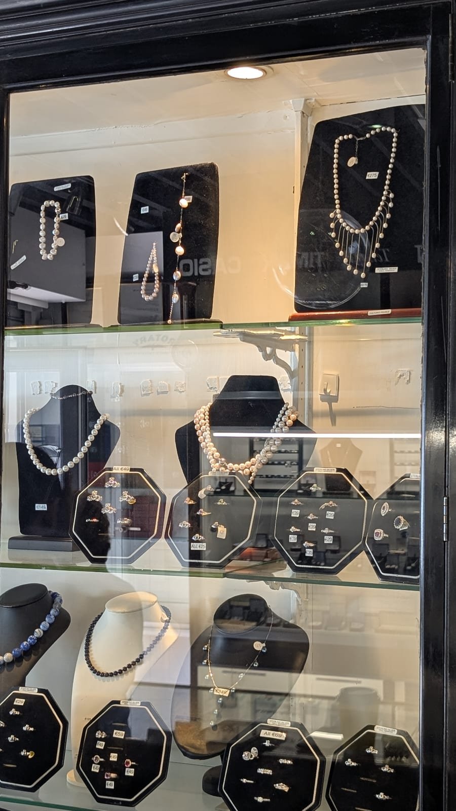 Pearl necklaces and rings on display